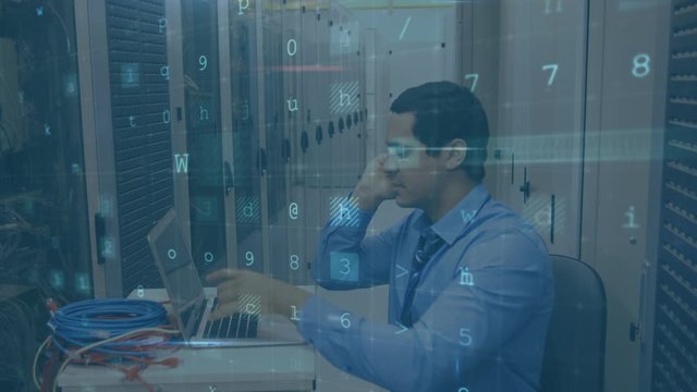 Worried man in a computer server room using a laptop