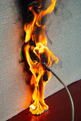 Burning electrical wiring and electrical outlet. Faulty wiring causes fires. Poor old wiring causes...