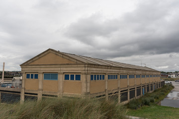 Fototapeta na wymiar abandoned building warehouse grey sky uk