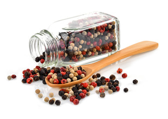 Mix from  kinds of pepper and  spoons isolated on white