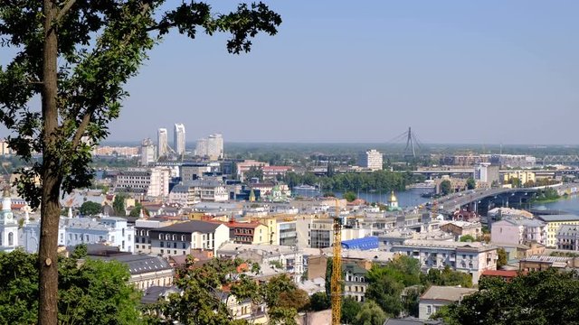 Panoramic video picture cityscape top view of the embankment from the right bank of the Dnieper in Kiev, Ukraine, 08/19/2019 district of the river station, Podil and the bridge under construction, hig