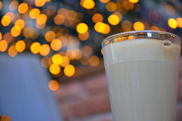  Aromatic coffee with a pattern in a glass cup on a brick wall background.