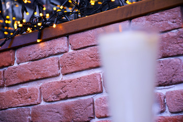 Aromatic coffee with a pattern in a glass cup on a brick wall background.