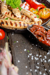 homemade hotdog sausages fried from red and white fish meat, in a vintage rustic plate bowl, fork...