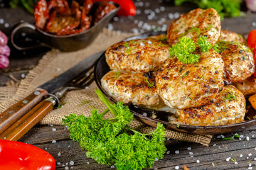 homemade meatballs, cutlets fried from red and white fish meat, in a vintage rustic bowl plate,...