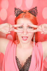 Beautiful redheaded young girl with fashion lace cat ears on head