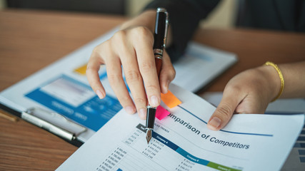 Young professional businesswoman planing the marketing strategy with charts and graphs