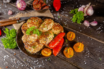 homemade meatballs, cutlets fried from red and white fish meat, in a vintage rustic bowl plate,...