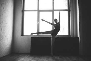 Fototapeta na wymiar Plasticity slim woman dancing near window. Professional dancer enjoy dance. Lady Dancer Training Modern Ballet In Class. Contemporary dance performer. Daylight, silhouette beautiful body. Dance theme