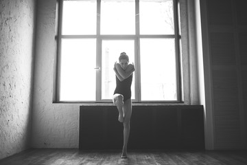Fototapeta na wymiar Plasticity slim woman dancing near window. Professional dancer enjoy dance. Lady Dancer Training Modern Ballet In Class. Contemporary dance performer. Daylight, silhouette beautiful body. Dance theme