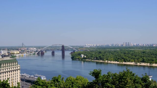 Panoramic video picture cityscape top view of the embankment from the right bank of the Dnieper in Kiev, Ukraine, 08/19/2019 district of the river station, Podil and the bridge under construction, hig