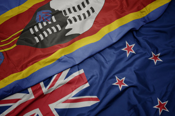 waving colorful flag of new zealand and national flag of swaziland.