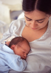 portrait of mom and her newborn male child vintage photography on film