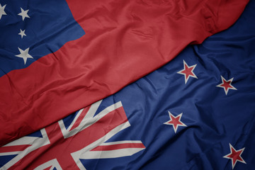 waving colorful flag of new zealand and national flag of Samoa.