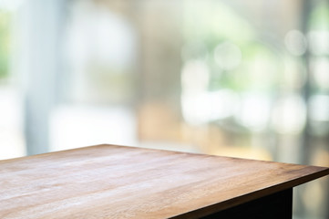 empty wood table with blur montage coffee shop or restaurant background.