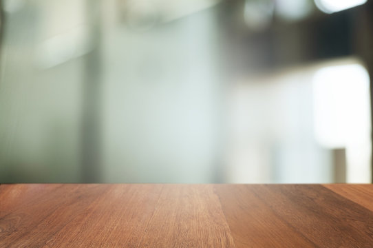 empty wood table with blur montage coffee shop or restaurant background.