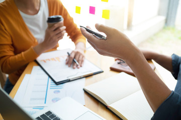 Business Administrator meeting with financial data in office room.