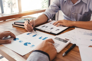 Business Administrator meeting with financial data in office room.