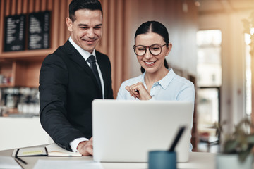 Smiling businesspeople working together at a table in an office