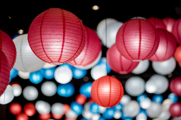 Colorful traditional Japanese paper lantern spread light on the old street ancient town,There are red  blue and white color old lantern,selective focus