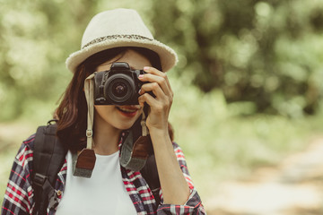 Happy travel together of fashionable photographer girl using retro camera.Tourist girl joyful capturing the moment.vacation take photo