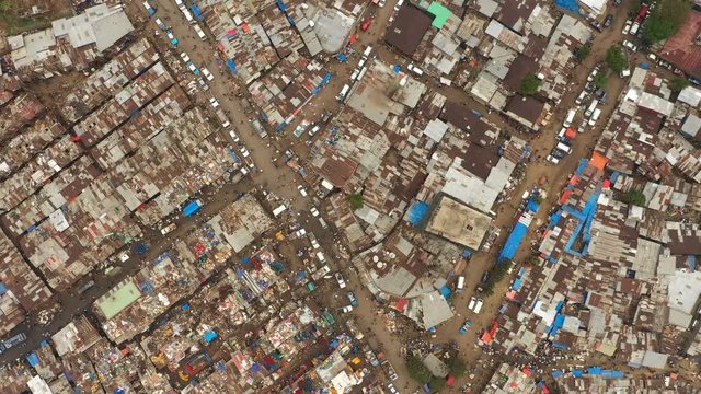 Overhead drone shot of poor neighborhood in recycling area of Mercato market, rooftops made of corrugated sheet, urbanization and expanding population Ethiopia Africa