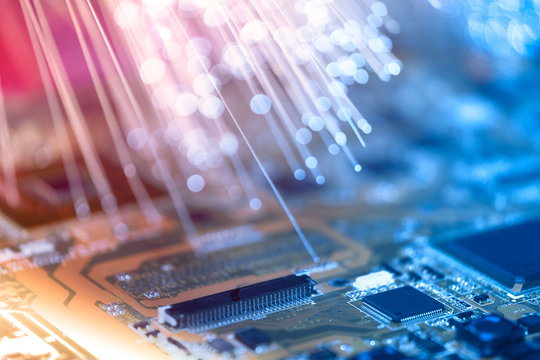 Closeup on electronic board and neon electric lights, blurred and toned electronic background