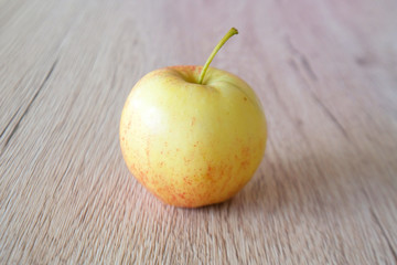 close up red apple isolated on wood background
