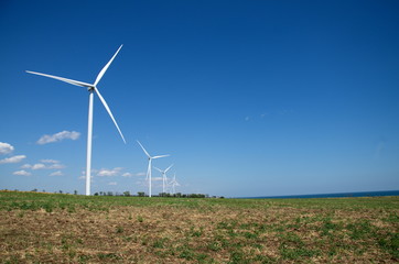 Wind power stations on the background of the steppe and the sea