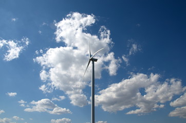 Fototapeta na wymiar Full size wind farm against a blue sky in the middle of a field