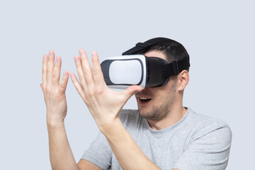 Young man using vr headset, experiencing virtual reality