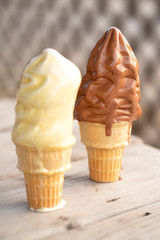 A Vanilla and Chocolate Ice Cream Cone Melting in the Summer Heat