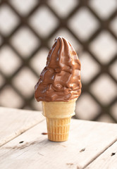 A Chocolate Soft Serve Ice Cream Cone Melting in the Summer Heat