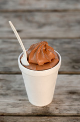 Cup of Chocolate Ice Cream on a Rustic Wooden Table