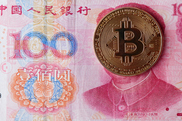 Chinese Yuan money and cryptocurrency Bitcoin close-up. Digital virtual internet currency investment concept