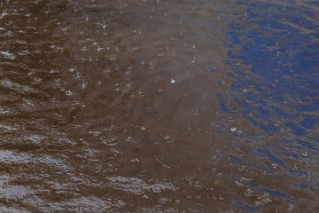puddle with raindrops,removed during the summer rain in the afternoon