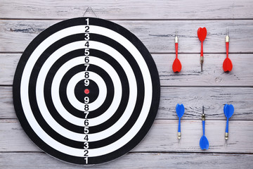 Dartboard with darts on wooden table