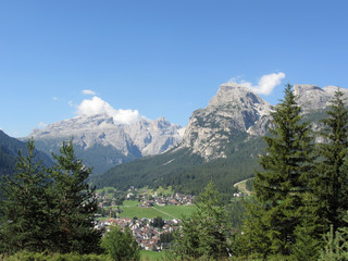 Plakat Alpine landscape with La Villa village, green pastures and firs against italian Dolomites at summer . La Villa, Bolzano, Alto Adige, South Tyrol, Italy