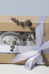 Lavender marshmallows in craft packaging. Tied with a ribbon with a bow. Several branches of lavender are woven into the bow.