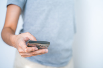 Concept technology: female oe hand texting by using mobile phone side view