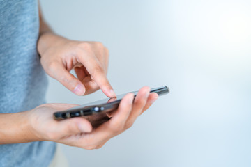 Concept technology: female two hand texting by using mobile phone side view