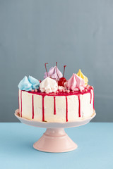 Birthday cake with glaze and cherries