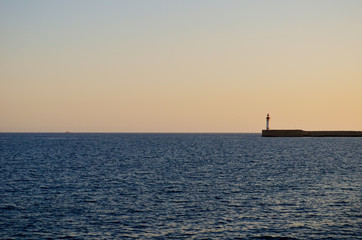 Lighthouse on the horizon  line between the sea and the sky, Almería, Spain