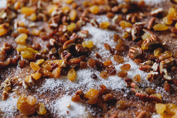 Close-up of pie filling ingredients with traditional winter spices like raisins, pecan, cinnamon and sugar.