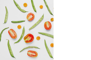 Pattern made of haricot, tomatoes, carrot on white background .Flat lay, top view, copy space. Food concept.