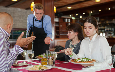 Fototapeta na wymiar Dissatisfied guests with waiter