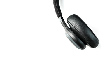 Wireless black headphones on white, isolate. On-ear headphones for playing games and listening to music tracks. Close-up