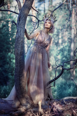 Fairytale girl in the branches of a tree