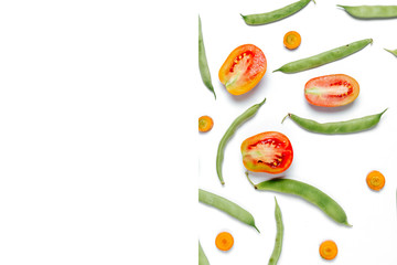 Creative layout made of haricot, tomatoes, carrot on white background .Flat lay, top view, copy space. Food concept.