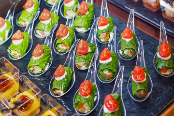 Banquet table with variety of snacks and appetizers. Beautifully decorated snacks with fresh vegetables